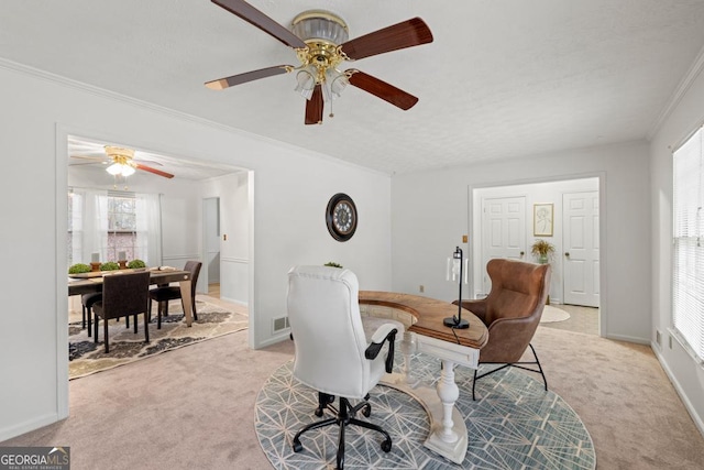 home office with ornamental molding and light carpet