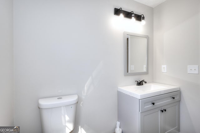 bathroom featuring vanity and toilet