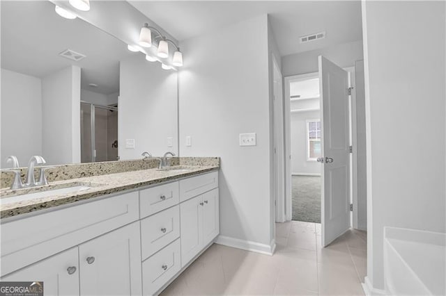 bathroom featuring tile patterned flooring, vanity, and an enclosed shower