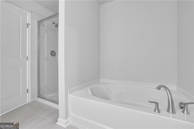 bathroom featuring tile patterned floors and separate shower and tub