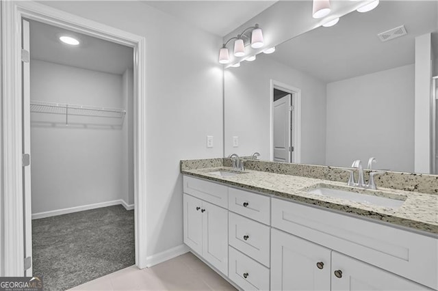 bathroom with tile patterned flooring and vanity