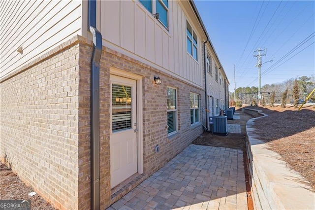 view of home's exterior with central AC and a patio area