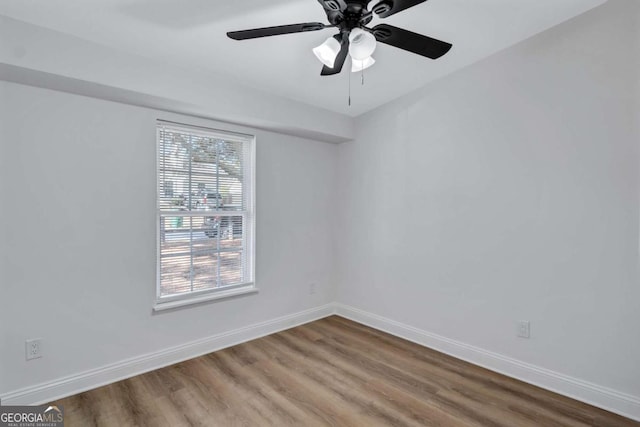 empty room featuring wood-type flooring and ceiling fan