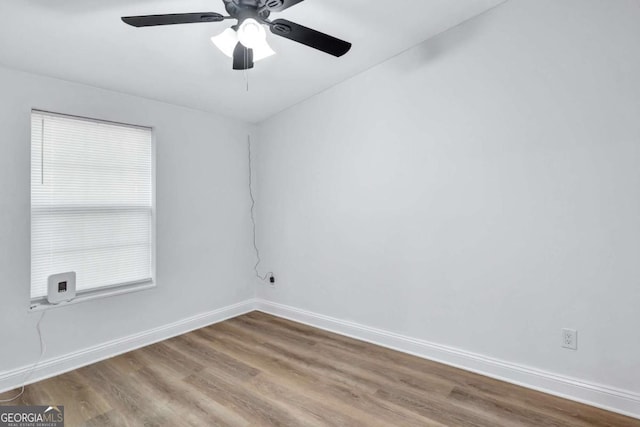 spare room with hardwood / wood-style floors and ceiling fan