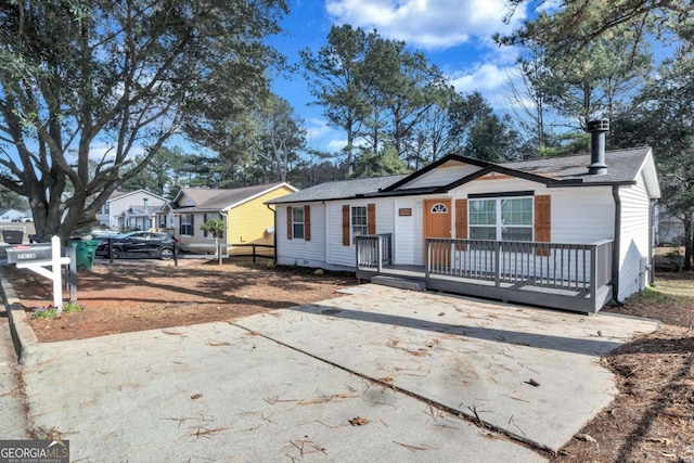 ranch-style home with a wooden deck