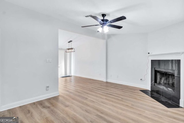 unfurnished living room featuring light hardwood / wood-style flooring, a fireplace, and ceiling fan