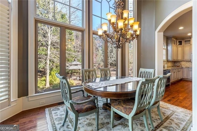 dining space featuring a notable chandelier and dark hardwood / wood-style floors