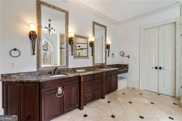 bathroom with crown molding, tile patterned floors, and vanity