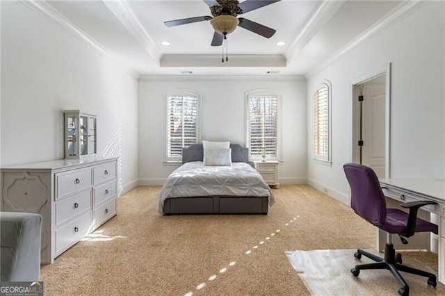 carpeted bedroom with ceiling fan, ornamental molding, and a raised ceiling