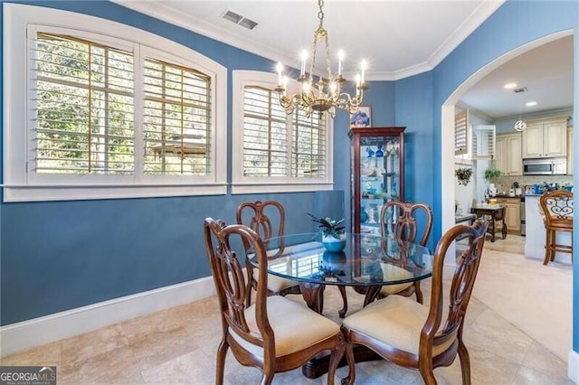 tiled dining area with crown molding and a notable chandelier