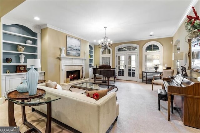 carpeted living room featuring french doors, an inviting chandelier, crown molding, built in features, and a fireplace