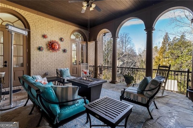 view of patio with ceiling fan and an outdoor fire pit