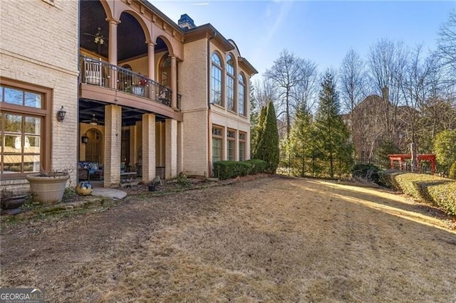 exterior space with ceiling fan and a balcony