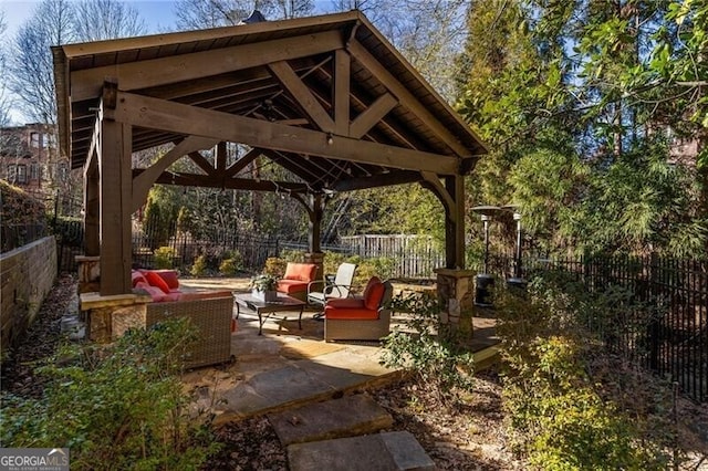 view of patio with an outdoor living space and a gazebo