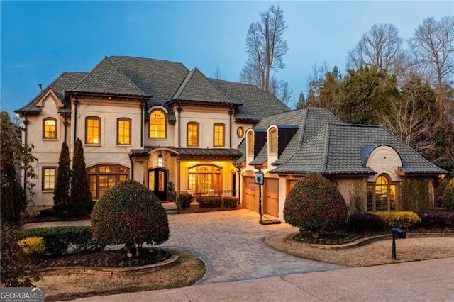 french provincial home with a garage