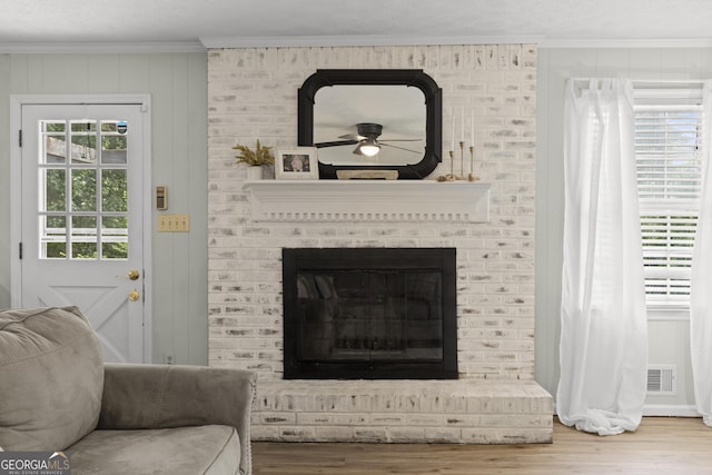 room details with crown molding, wood-type flooring, and a fireplace