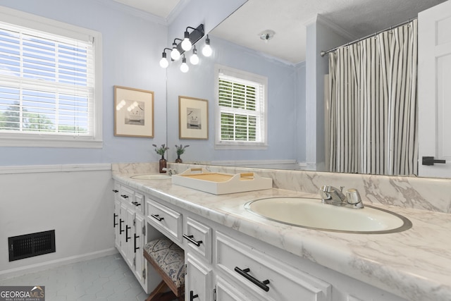 bathroom with crown molding, plenty of natural light, a shower with shower curtain, and vanity