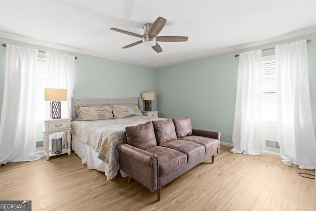 bedroom with ornamental molding and light wood-type flooring