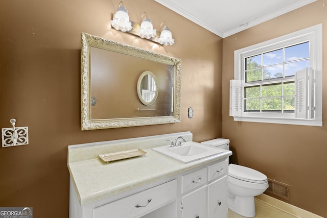 bathroom featuring vanity, ornamental molding, and toilet