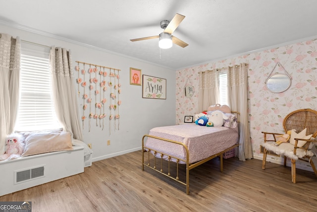 bedroom featuring crown molding, ceiling fan, and light hardwood / wood-style floors