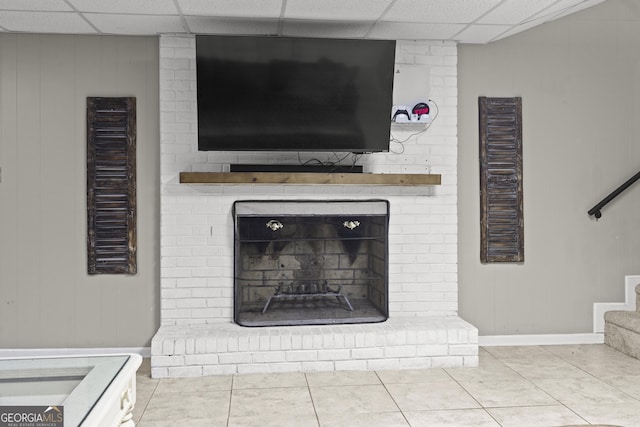 room details with a drop ceiling and a fireplace