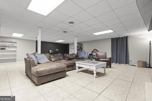 tiled living room featuring a drop ceiling