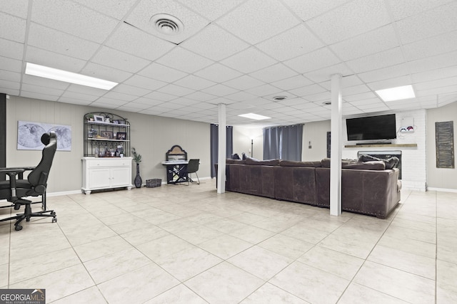 living room with tile patterned floors and a drop ceiling