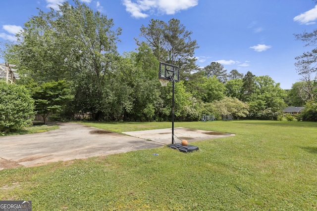 view of sport court featuring a lawn