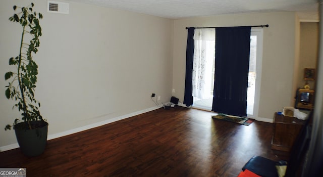 entrance foyer featuring dark hardwood / wood-style flooring, plenty of natural light, and a textured ceiling