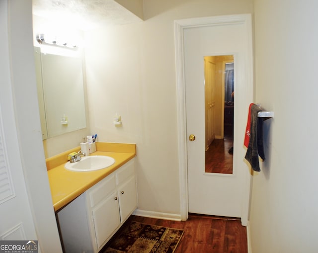 bathroom featuring hardwood / wood-style flooring and vanity