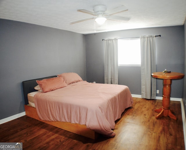 bedroom featuring ceiling fan and hardwood / wood-style floors