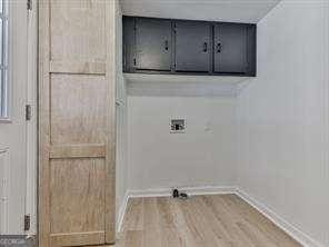 laundry room featuring washer hookup and wood-type flooring