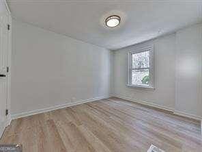 unfurnished room with light hardwood / wood-style floors