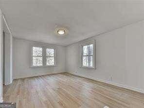 empty room featuring plenty of natural light and light hardwood / wood-style floors