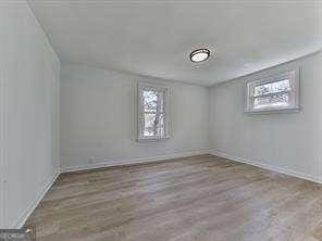 spare room featuring light wood-type flooring