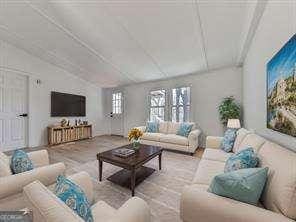 living room featuring lofted ceiling