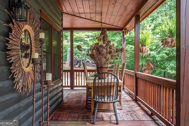 unfurnished sunroom featuring vaulted ceiling and wood ceiling