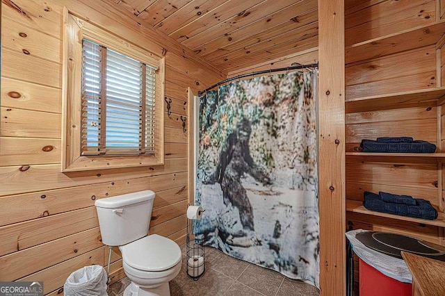 bathroom with a shower with curtain, wooden ceiling, wooden walls, and toilet