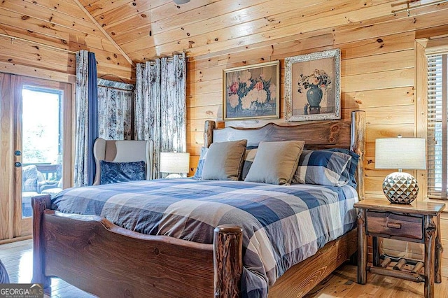 bedroom featuring wood walls, wood ceiling, vaulted ceiling, and wood finished floors