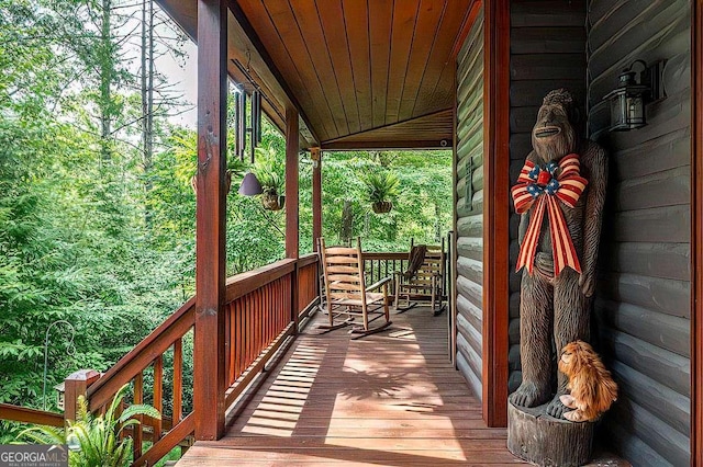 wooden terrace with a porch