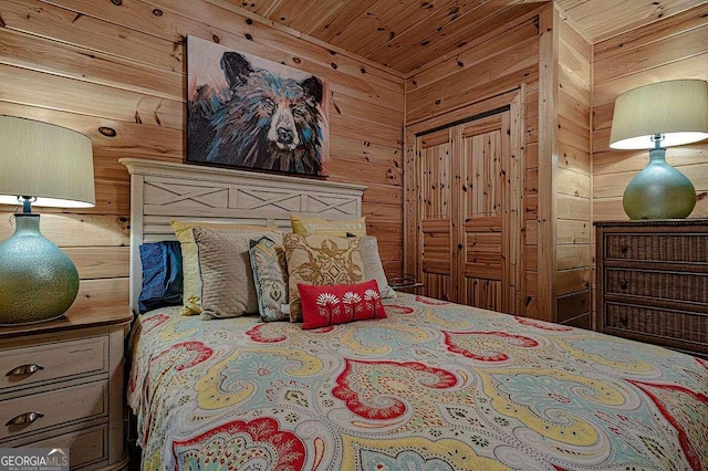 bedroom with wooden ceiling and wood walls