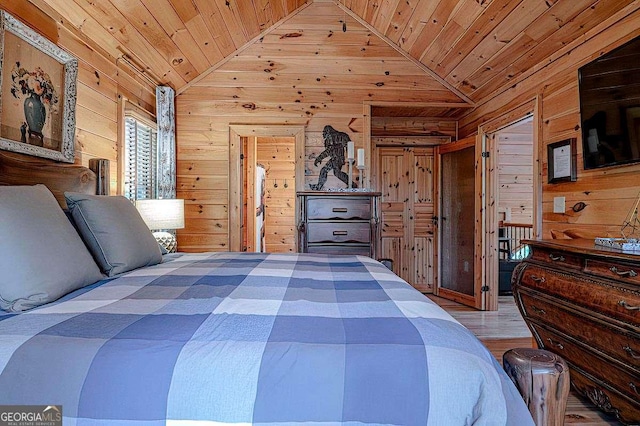 bedroom with lofted ceiling, wooden walls, hardwood / wood-style floors, and wooden ceiling