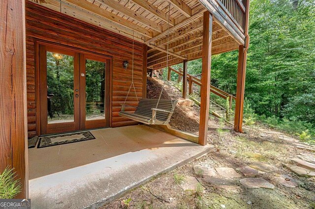 sunroom with lofted ceiling and wood ceiling