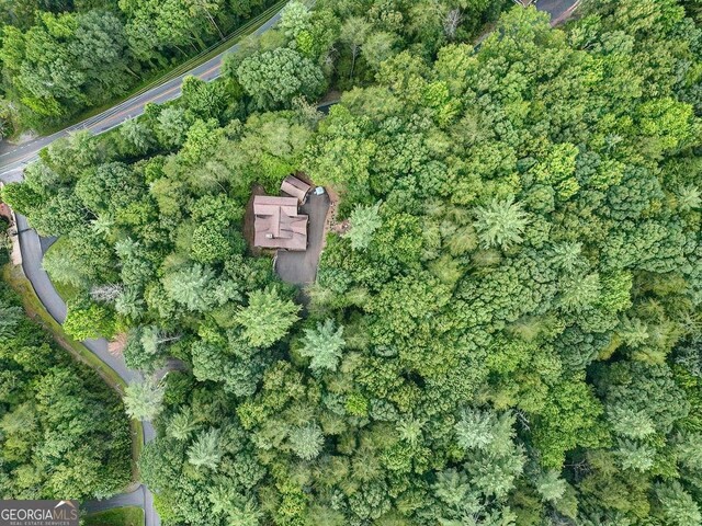 birds eye view of property featuring a view of trees