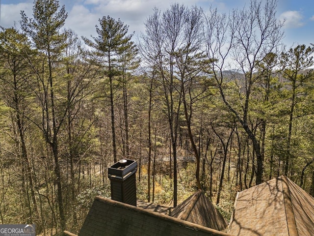 exterior space featuring a view of trees