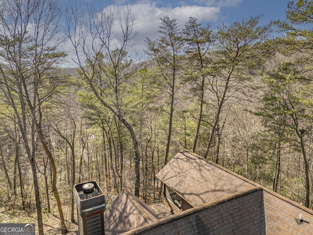 exterior space with a wooded view