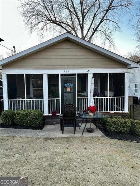 back of house with a sunroom