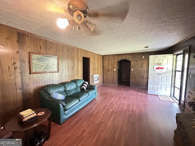 6100 White House Pkwy, Warm Springs, GA 31830 - unfurnished living room featuring visible vents, arched walkways, a ceiling fan, a textured ceiling, and wood finished floors
