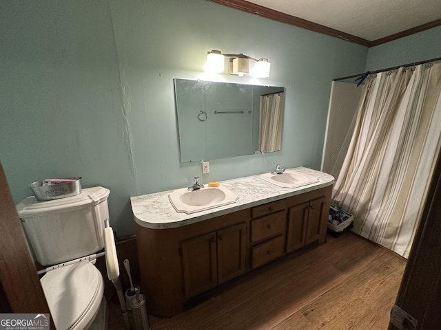 6100 White House Pkwy, Warm Springs, GA 31830 - bathroom featuring toilet, a sink, ornamental molding, and wood finished floors