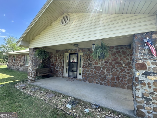 6100 White House Pkwy, Warm Springs, GA 31830 - property entrance featuring stone siding, a lawn, and covered porch